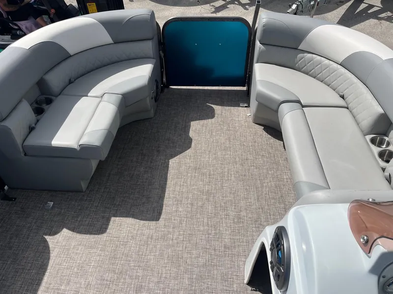 Slide: The Image of 2024 Lexington 17 Emerg boat interior with gray seating and carpeted floor. - 7