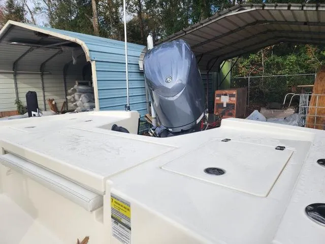 Slide: The Image of 2024 Pathfinder 2200 TRS boat with Yamaha outboard motor in a storage area. - 11