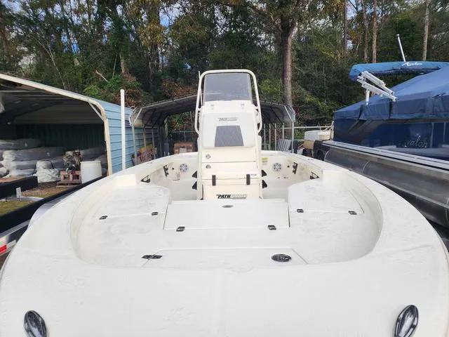 Slide: The Image of 2024 Pathfinder 2200 TRS boat in storage, surrounded by trees and other boats. - 15