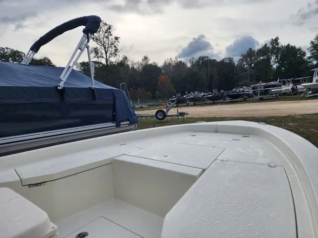 Slide: The Image of 2024 Pathfinder 2200 TRS boat in a marina, surrounded by trees and trailers. - 19