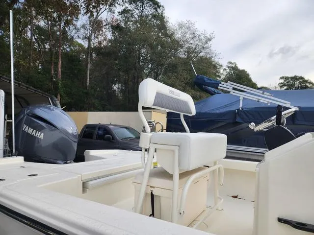 Slide: The Image of 2024 Pathfinder 2200 TRS boat with Yamaha engine, parked outdoors. - 21