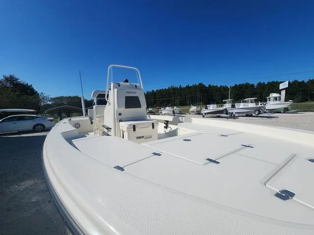 Slide: The Image of 2024 Pathfinder 2200 TRS boat in a sunny outdoor setting, showcasing sleek design and spacious deck. - 25