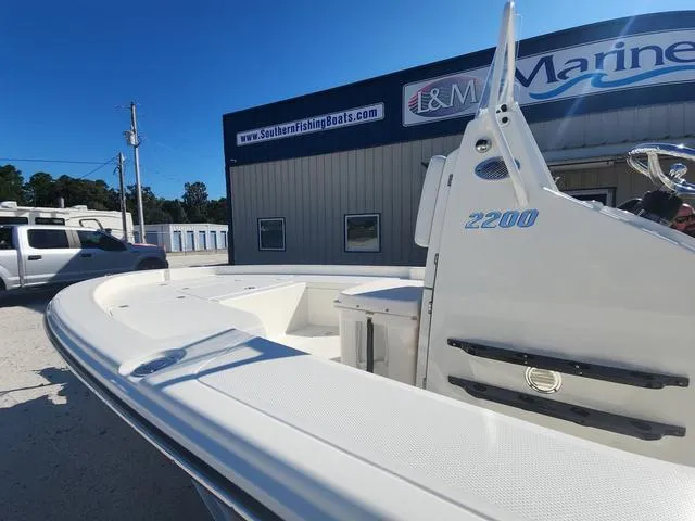 Slide: The Image of 2024 Pathfinder 2200 TRS boat at dealership, showcasing sleek design and modern features. - 26