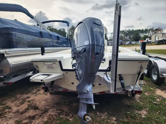 Slide: The Image of 2024 Pathfinder 2200 TRS boat with powerful outboard motor, parked on a trailer. - 28