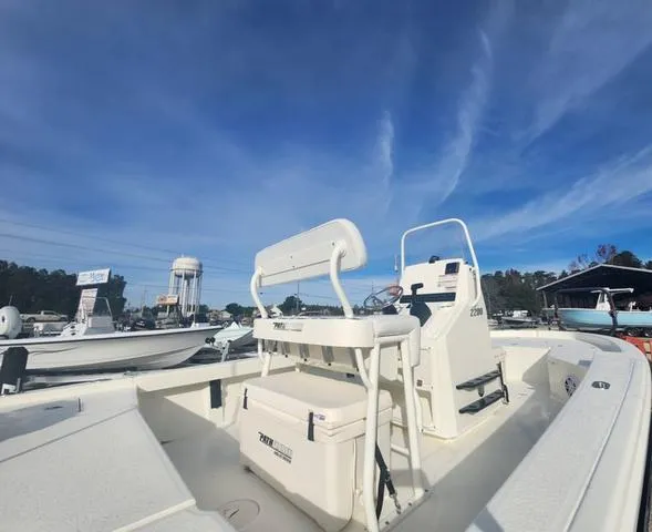 Slide: The Image of 2024 Pathfinder 2200 TRS boat under clear blue sky at marina. - 29