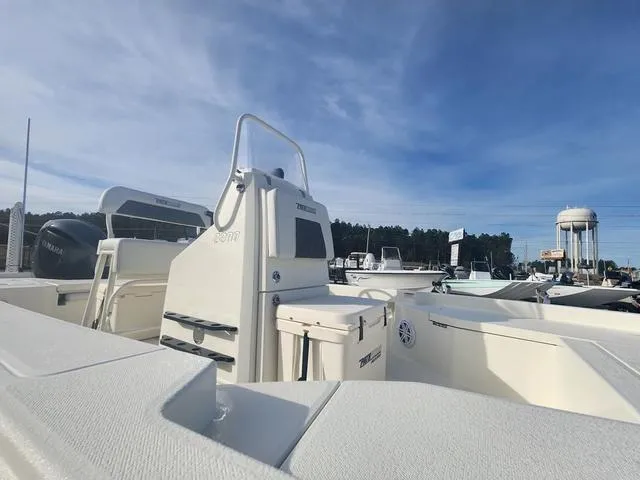 Slide: The Image of 2024 Pathfinder 2200 TRS boat with Yamaha engine, docked under clear blue sky. - 31