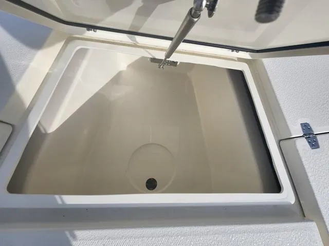 Slide: The Image of 2024 Pathfinder 2200 TRS boat storage compartment with open lid and hydraulic support. - 34