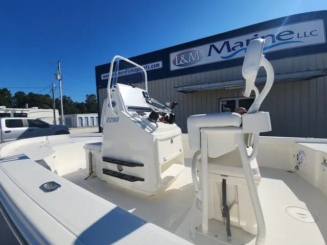 Slide: The Image of 2024 Pathfinder 2200 TRS boat at L&M Marine dealership, sunny day. - 36
