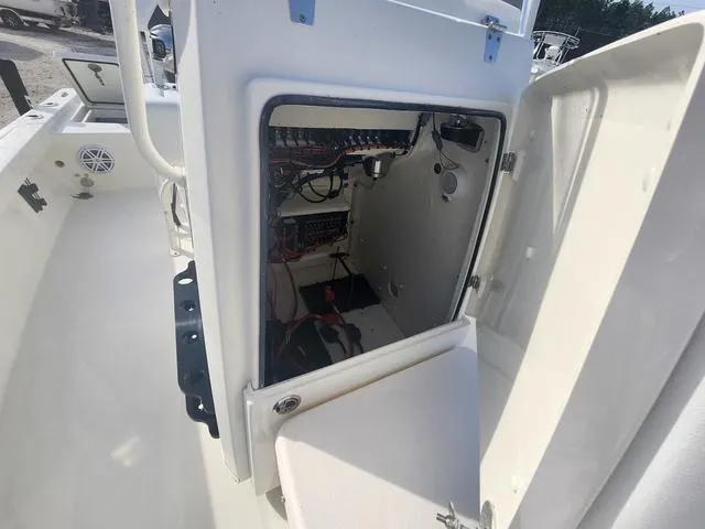 Slide: The Image of 2024 Pathfinder 2200 TRS boat interior showing open storage compartment with wiring. - 37