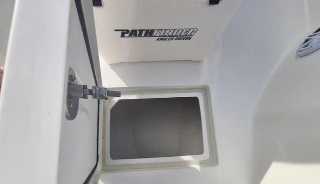 Slide: The Image of 2024 Pathfinder 2200 TRS boat storage compartment with open hatch and visible branding. - 40