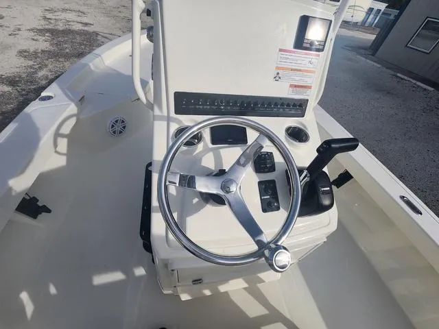 Slide: The Image of 2024 Pathfinder 2200 TRS boat console with steering wheel and controls. - 42