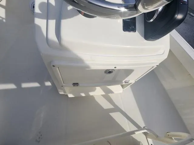 Slide: The Image of 2024 Pathfinder 2200 TRS boat console with steering wheel and storage compartment. - 43