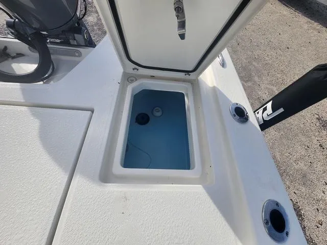 Slide: The Image of 2024 Pathfinder 2200 TRS boat livewell with open lid, showcasing interior details. - 46