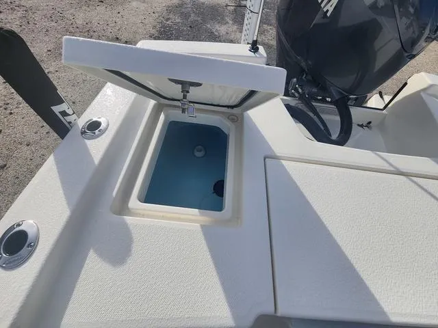 Slide: The Image of 2024 Pathfinder 2200 TRS boat with open storage compartment and visible engine. - 47