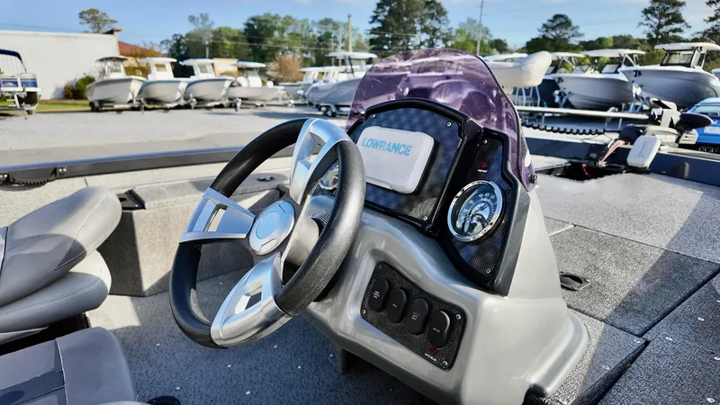 Slide: The Image of 2021 G3 Sportsman 1610 boat dashboard with steering wheel and control panel. - 6
