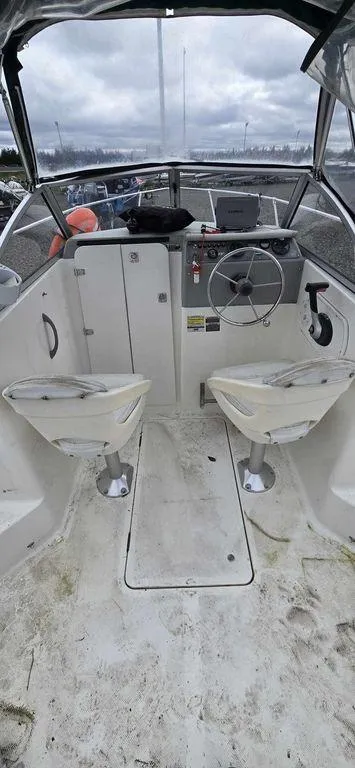 Slide: The Image of 2006 Bayliner Trophy 1802 WA boat interior with steering wheel and seating. - 4