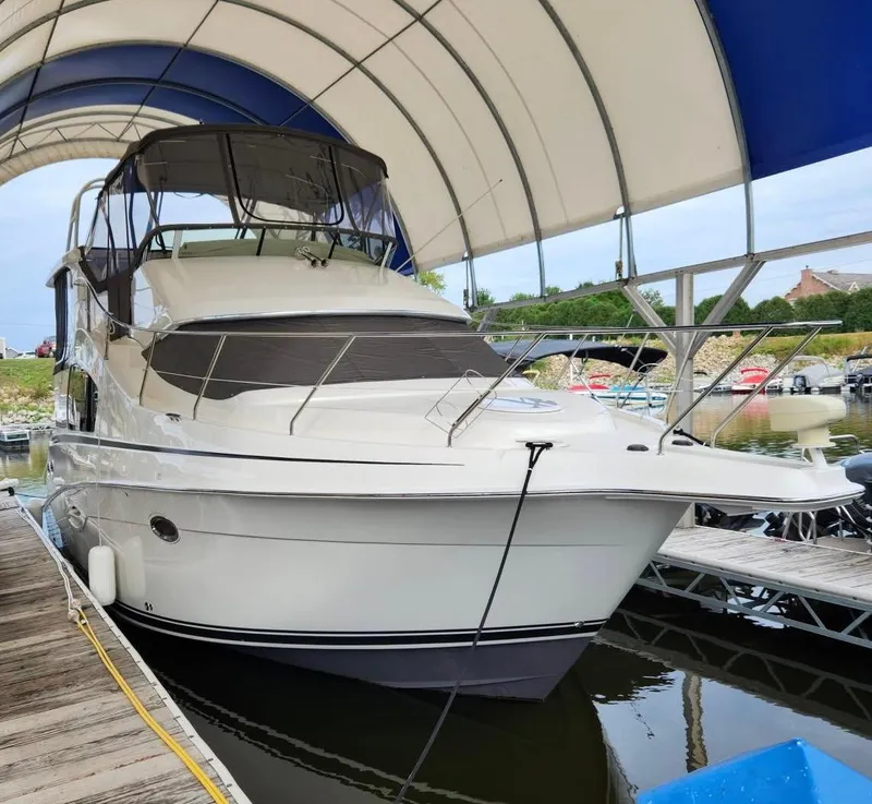 Slide: The Image of 2005 Silverton 35 Motor Yacht docked under a canopy. - 1