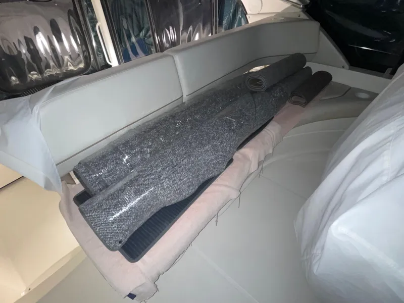 Slide: The Image of Interior of 2005 Silverton 35 Motor Yacht with rolled carpets on seating area. - 17