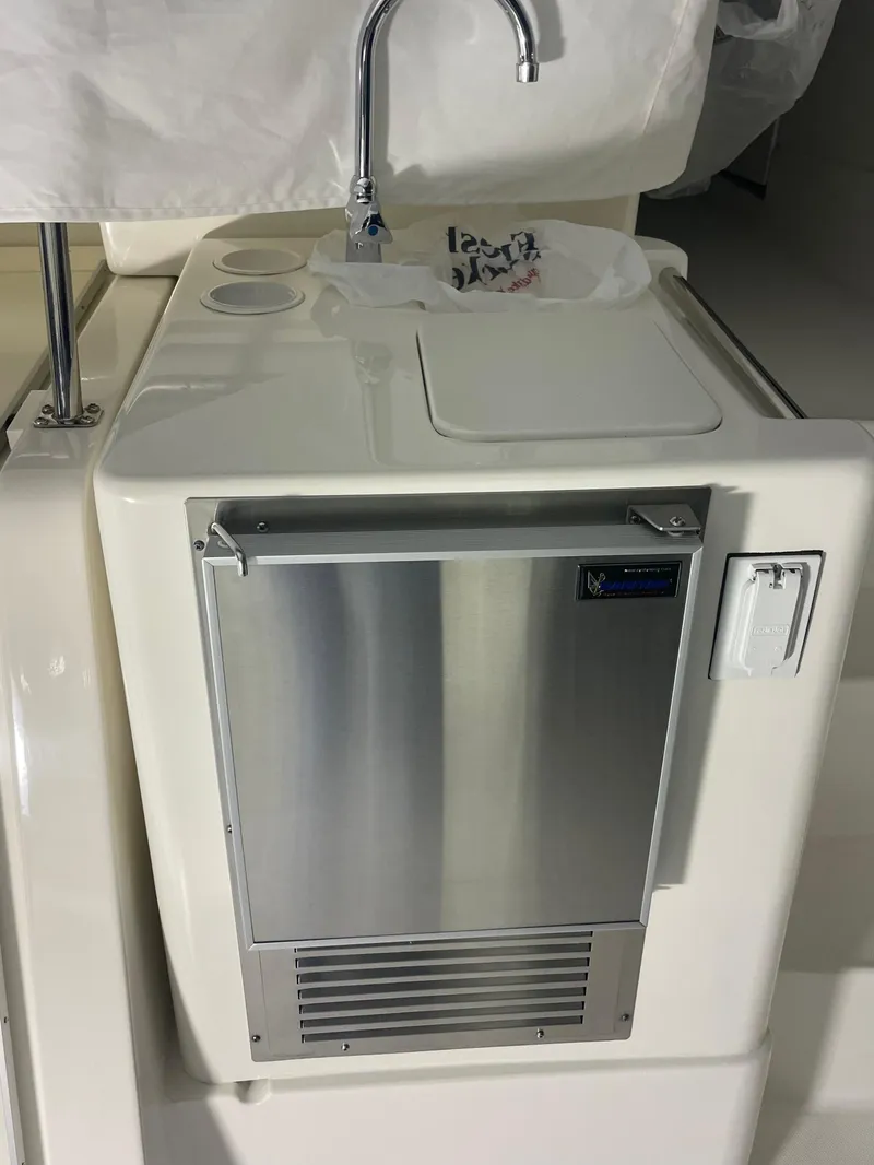 Slide: The Image of 2005 Silverton 35 Motor Yacht kitchenette with sink and stainless steel mini-fridge. - 19