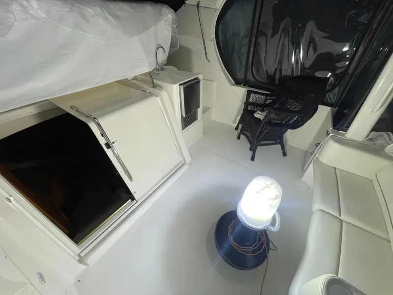 Slide: The Image of 2005 Silverton 35 Motor Yacht interior with seating, table, and ambient lighting. - 22