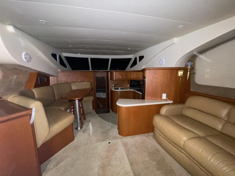 Slide: The Image of Interior of 2005 Silverton 35 Motor Yacht with beige seating and wooden cabinetry. - 25