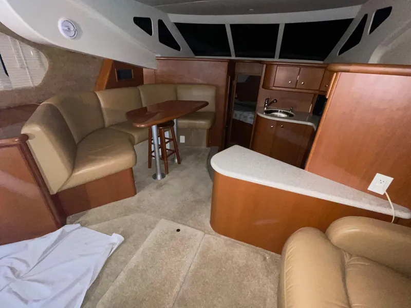 Slide: The Image of Interior of 2005 Silverton 35 Motor Yacht with seating, table, and kitchenette. - 27