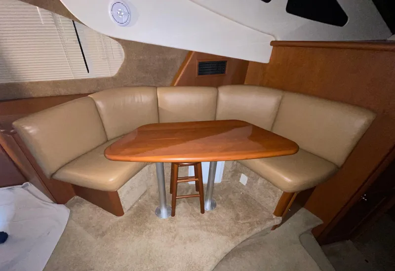 Slide: The Image of 2005 Silverton 35 Motor Yacht interior with beige seating and wooden table. - 29