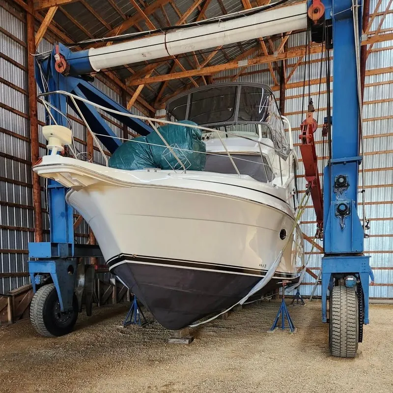 Slide: The Image of 2005 Silverton 35 Motor Yacht in a boat lift inside a storage facility. - 3