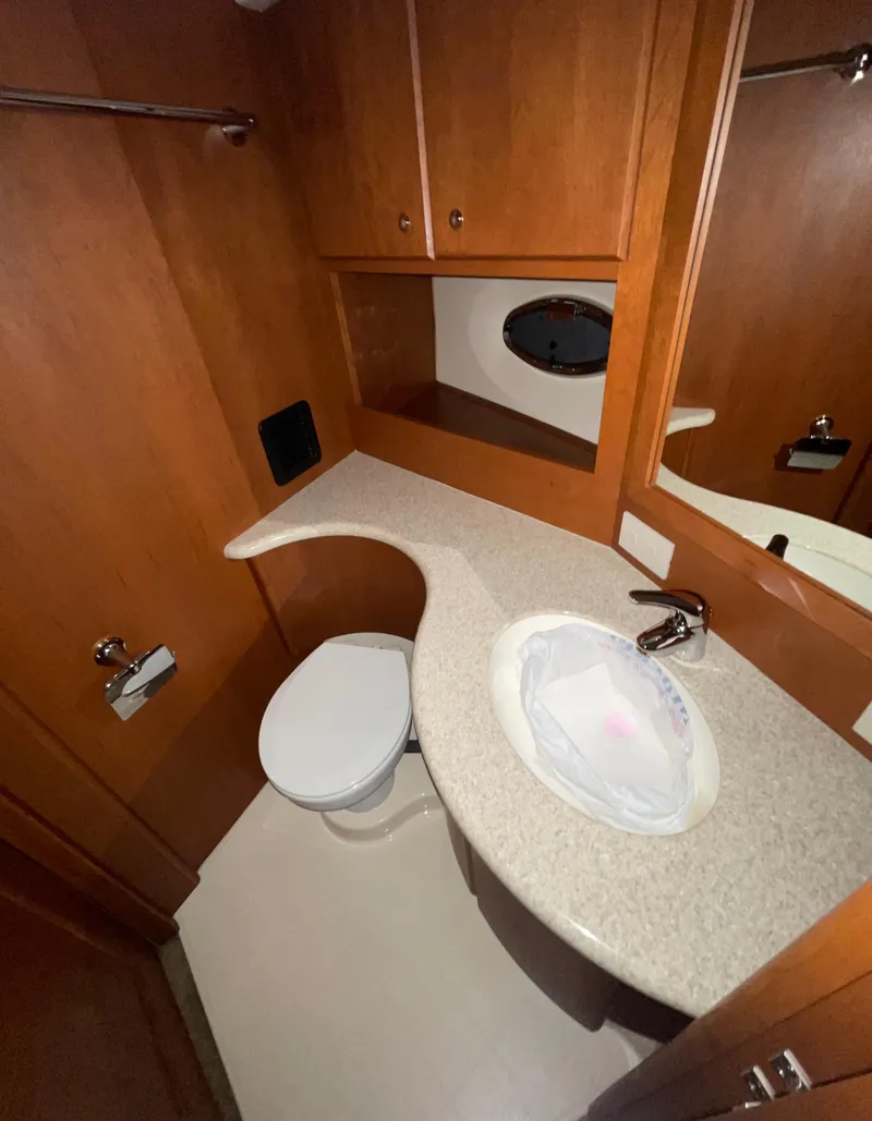Slide: The Image of 2005 Silverton 35 Motor Yacht bathroom with wooden cabinets and modern fixtures. - 32