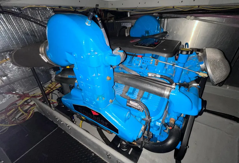 Slide: The Image of Engine room of 2005 Silverton 35 Motor Yacht with blue engine components. - 40