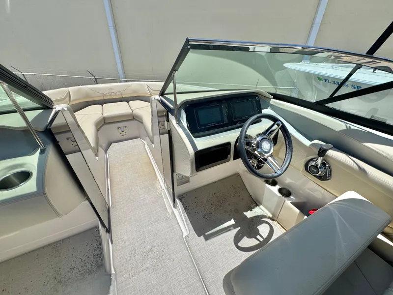 Slide: The Image of Interior of a 2020 Regal LS4 boat, featuring steering wheel and seating area. - 10