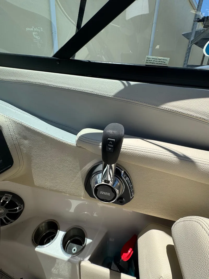 Slide: The Image of 2020 Regal LS4 boat throttle control and cup holders in cockpit area. - 11