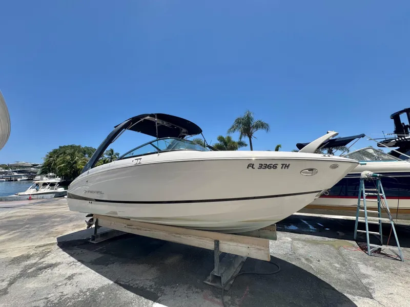 Slide: The Image of 2020 Regal LS4 boat on dry dock, sunny marina background. - 2