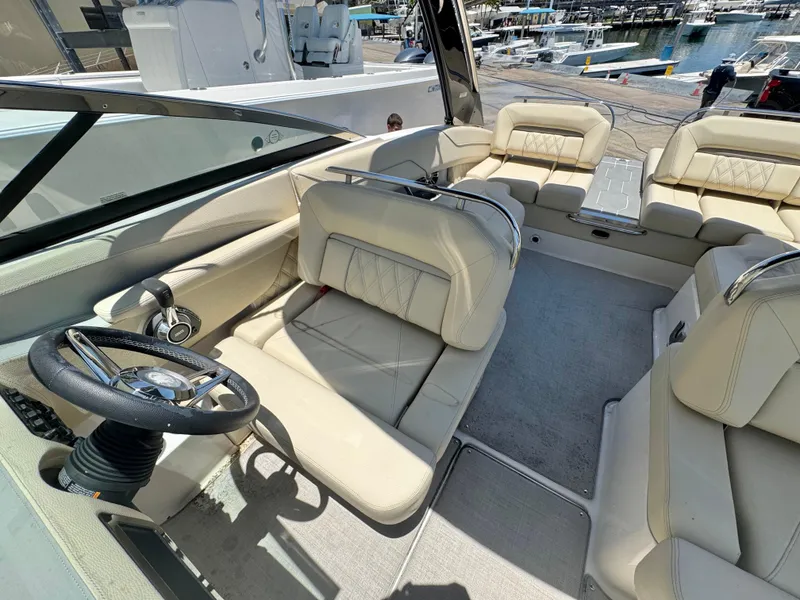 Slide: The Image of 2020 Regal LS4 boat interior with beige seating and steering wheel, docked at marina. - 6