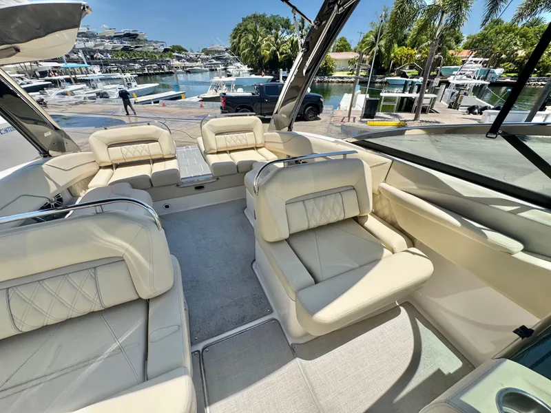 Slide: The Image of Luxurious 2020 Regal LS4 boat interior with cream leather seating, docked at a marina. - 8