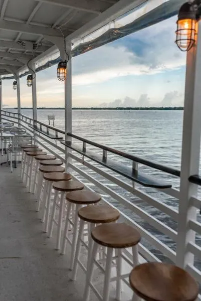 Slide: The Image of Riverside view from a 1984 Custom Paddle Wheel boat with bar stools and ambient lighting. - 14