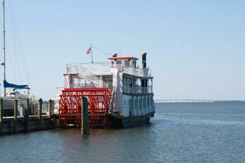 Slide: The Image of Vintage 1984 custom paddle wheel boat docked by the water. - 18