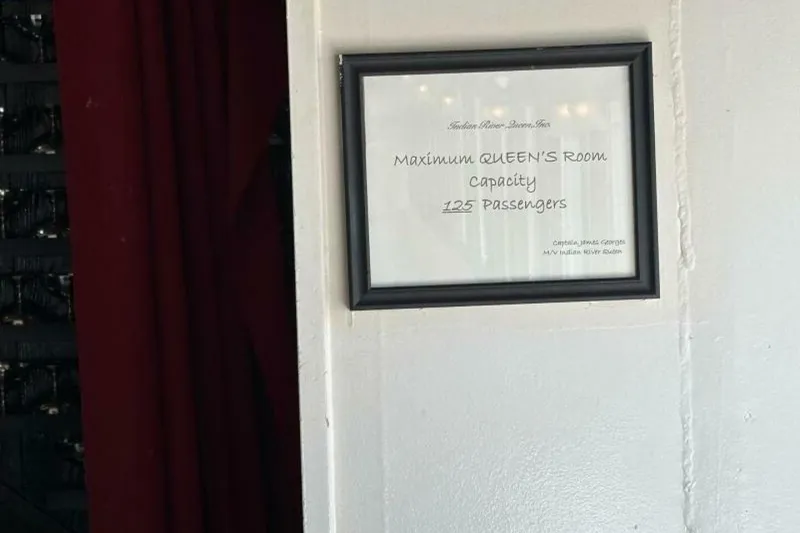 Slide: The Image of Framed sign indicating maximum capacity of 125 passengers in Queen's Room, Custom Paddle Wheel, 1984. - 21