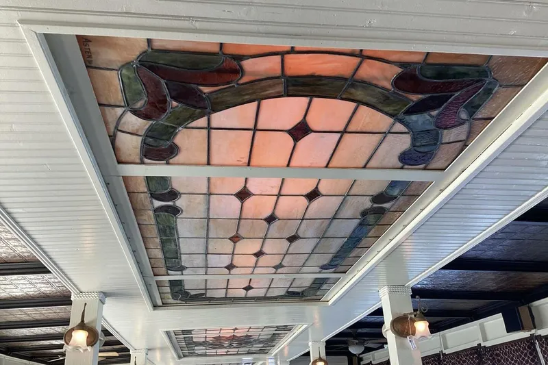 Slide: The Image of Stained glass ceiling panel with intricate design on a custom 1984 Paddle Wheel. - 22