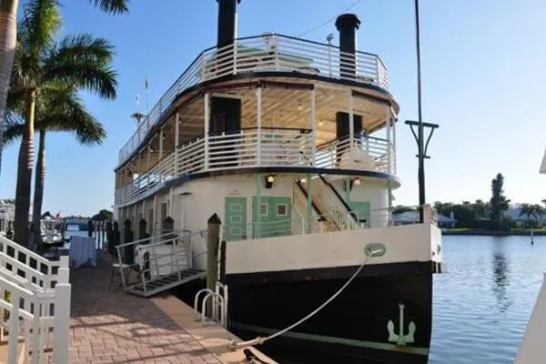 Slide: The Image of Vintage 1984 custom paddle wheel boat docked by palm trees. - 4