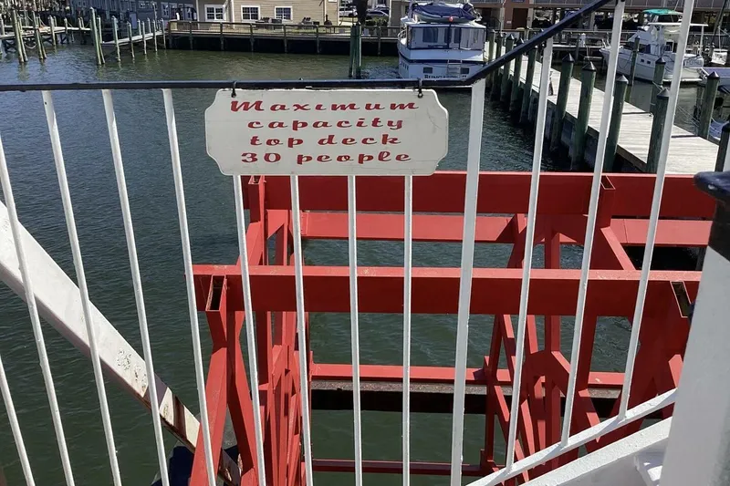 Slide: The Image of Red paddle wheel boat with capacity sign, docked at marina, Custom Paddle Wheel 1984. - 46