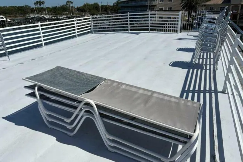 Slide: The Image of Rooftop deck with stacked lounge chairs on a 1984 Custom Paddle Wheel boat. - 50