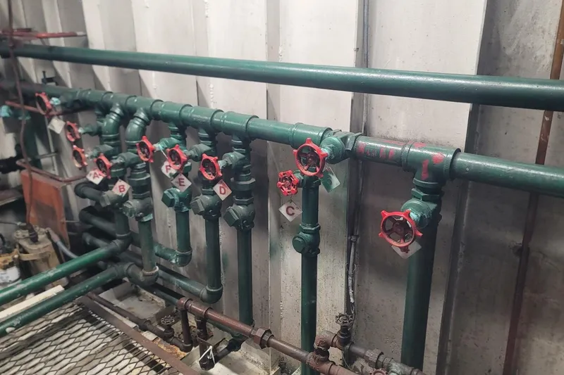 Slide: The Image of Industrial piping system with labeled red valves, Custom Paddle Wheel, 1984. - 54