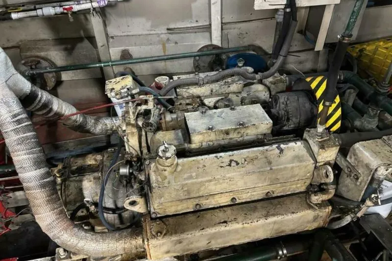 Slide: The Image of 1984 Custom Paddle Wheel engine with visible pipes and mechanical components. - 58