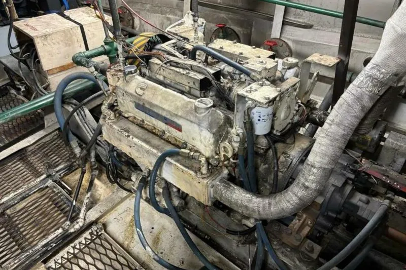 Slide: The Image of 1984 Custom Paddle Wheel engine with hoses and mechanical components in a workshop setting. - 59