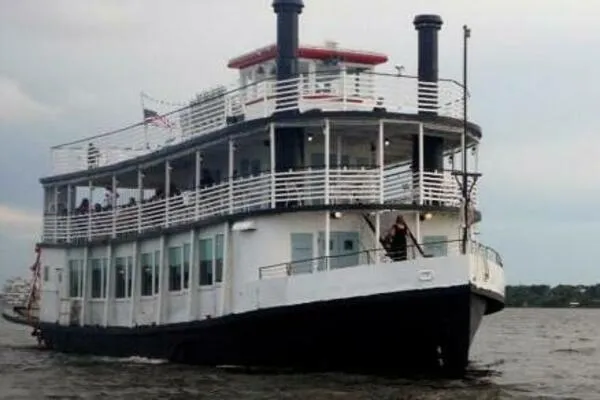 Slide: The Image of Vintage 1984 custom paddle wheel boat cruising on a calm river. - 6