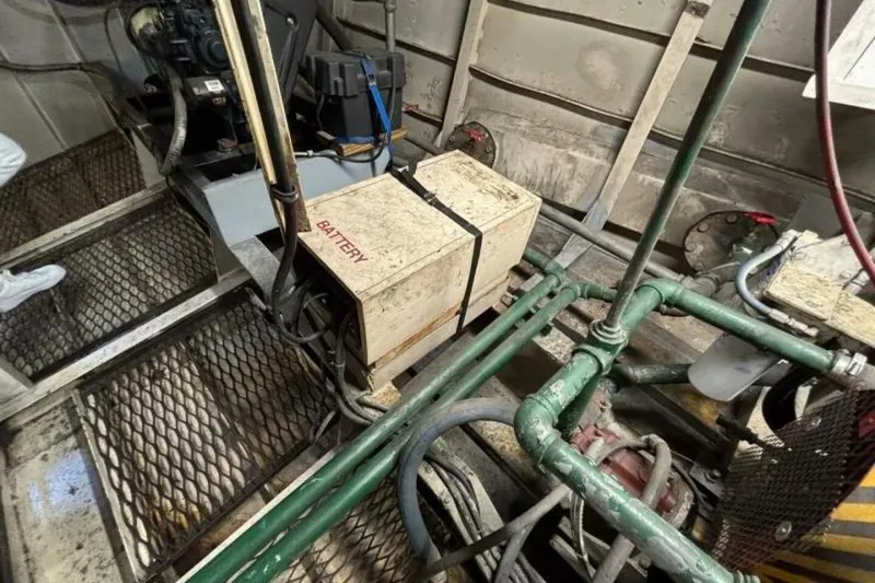 Slide: The Image of Engine room of a 1984 Custom Paddle Wheel boat with visible battery and machinery. - 60