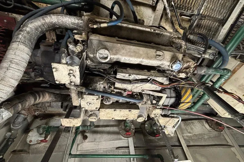 Slide: The Image of Old custom paddle wheel engine from 1984 with visible pipes and wiring. - 62