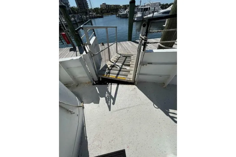 Slide: The Image of Boat deck with ramp leading to dock, Custom Paddle Wheel, 1984, marina view. - 64