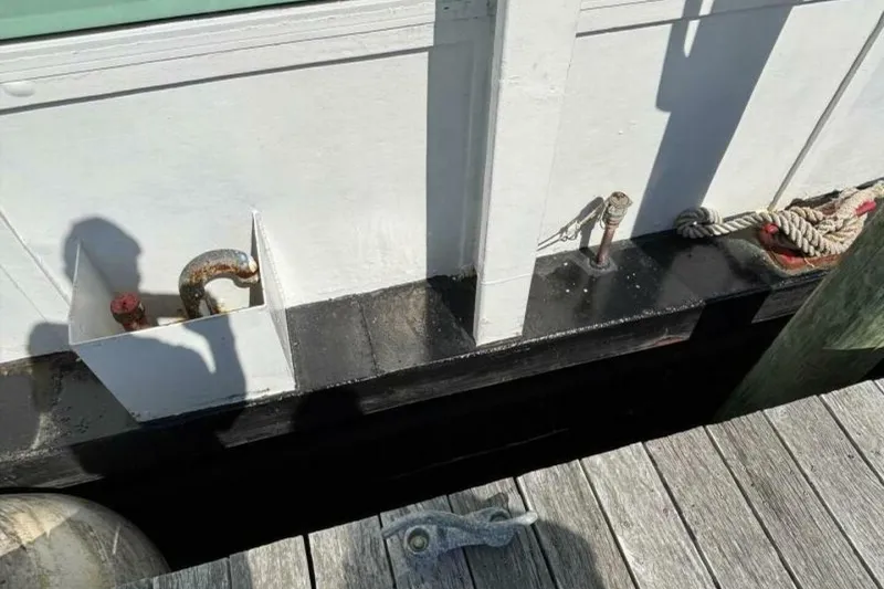 Slide: The Image of Docked custom paddle wheel boat from 1984 with ropes and metal fixtures. - 66